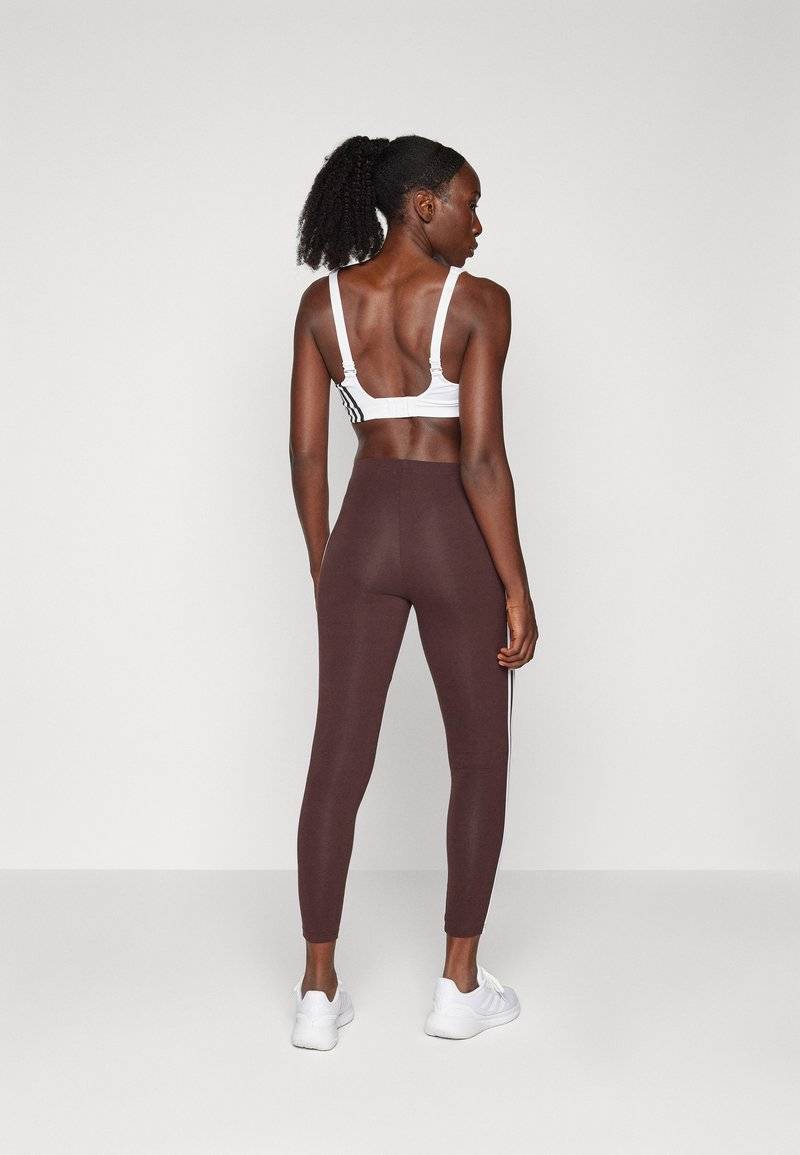 adidas Sportswear adidas Sportswear ESSENTIALS 3 STRIPES HIGH WAISTED - Leggings - shadow brown Tiefpreis