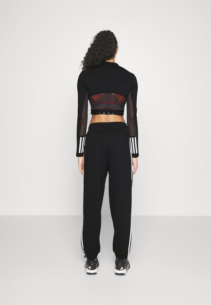 adidas Sportswear adidas Sportswear ESSENTIALS 3-STRIPES LOOSE-FIT - Tracksuit bottoms Jubiläumsangebot
