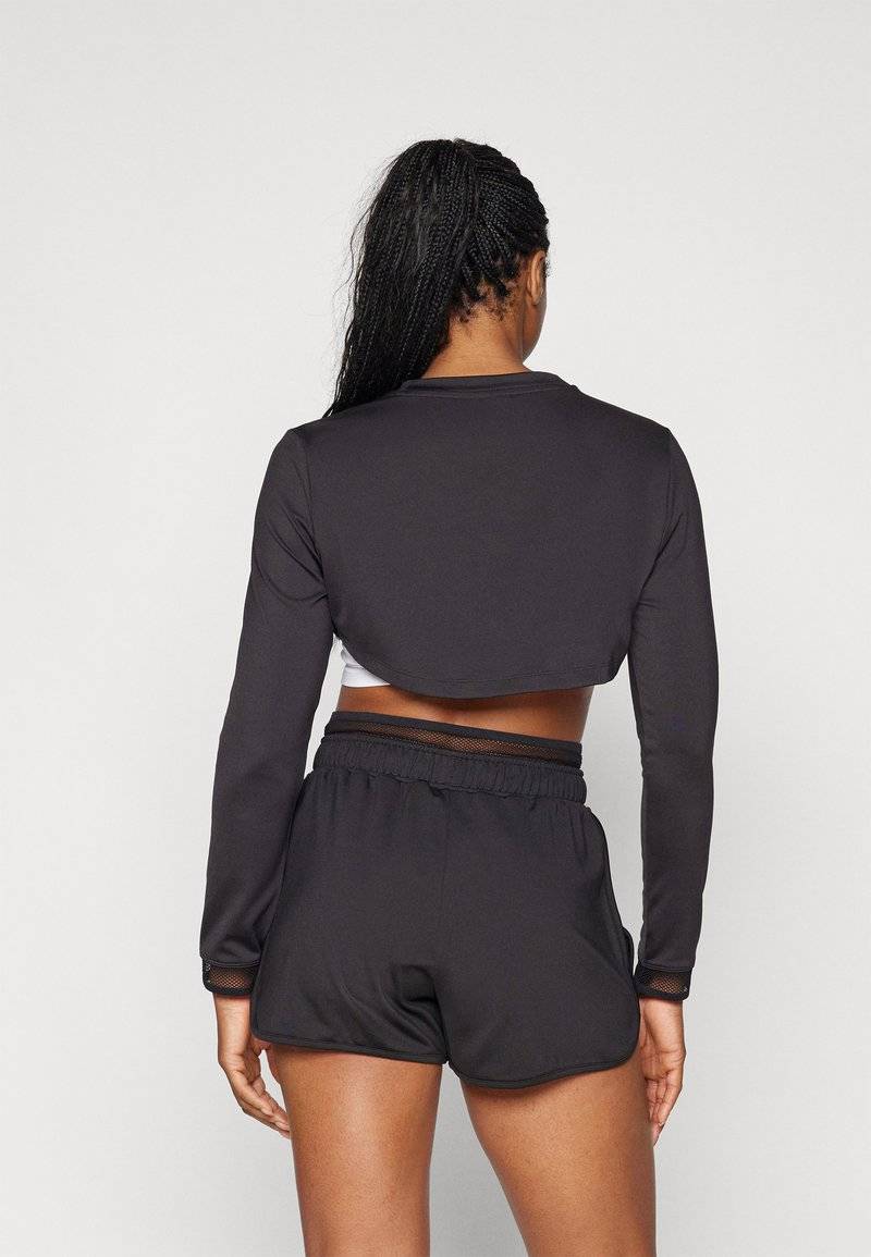 Puma Puma PAMELA REIF CROPPED - Long sleeved top - black Fabrik Onlineshop