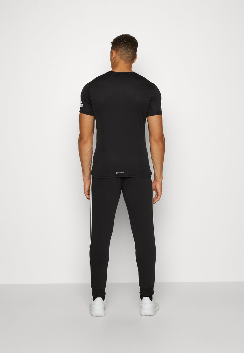 adidas Sportswear adidas Sportswear ESSENTIALS TAPERED CUFF 3 STRIPES PANTS - Tracksuit bottoms - black white Preisnachlass