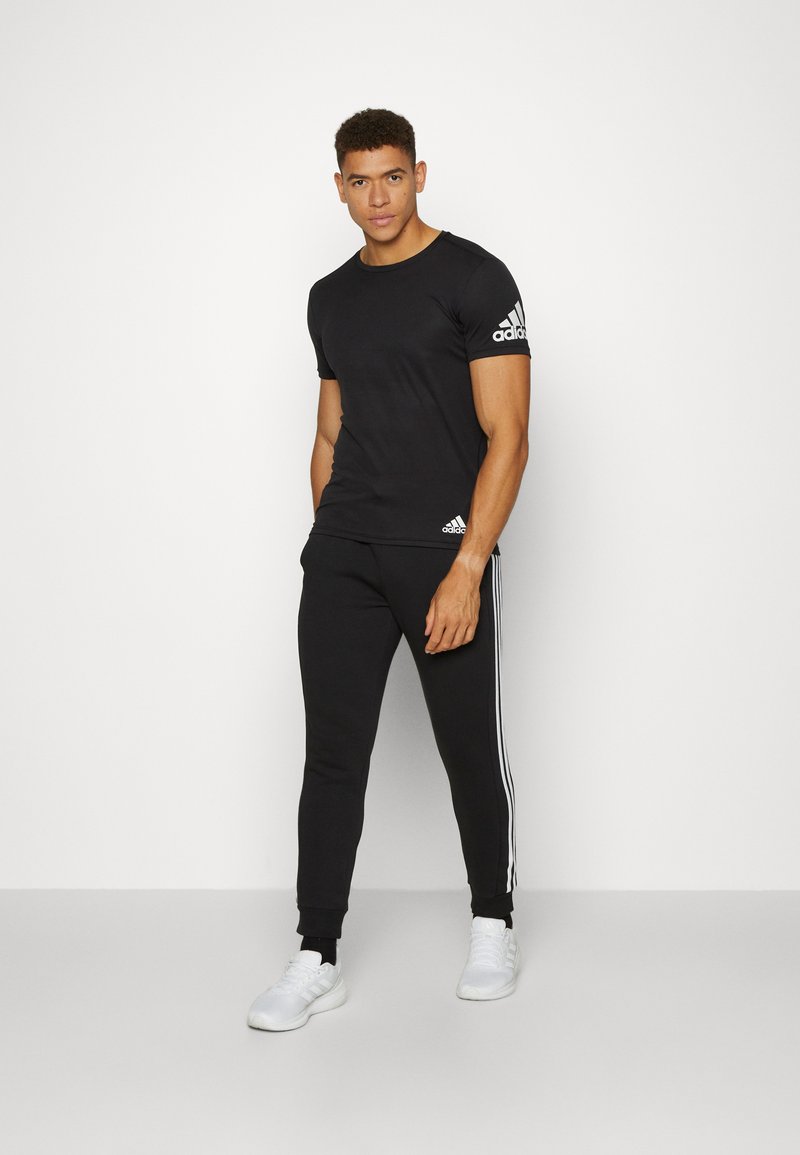 adidas Sportswear adidas Sportswear ESSENTIALS TAPERED CUFF 3 STRIPES PANTS - Tracksuit bottoms - black white Preisnachlass