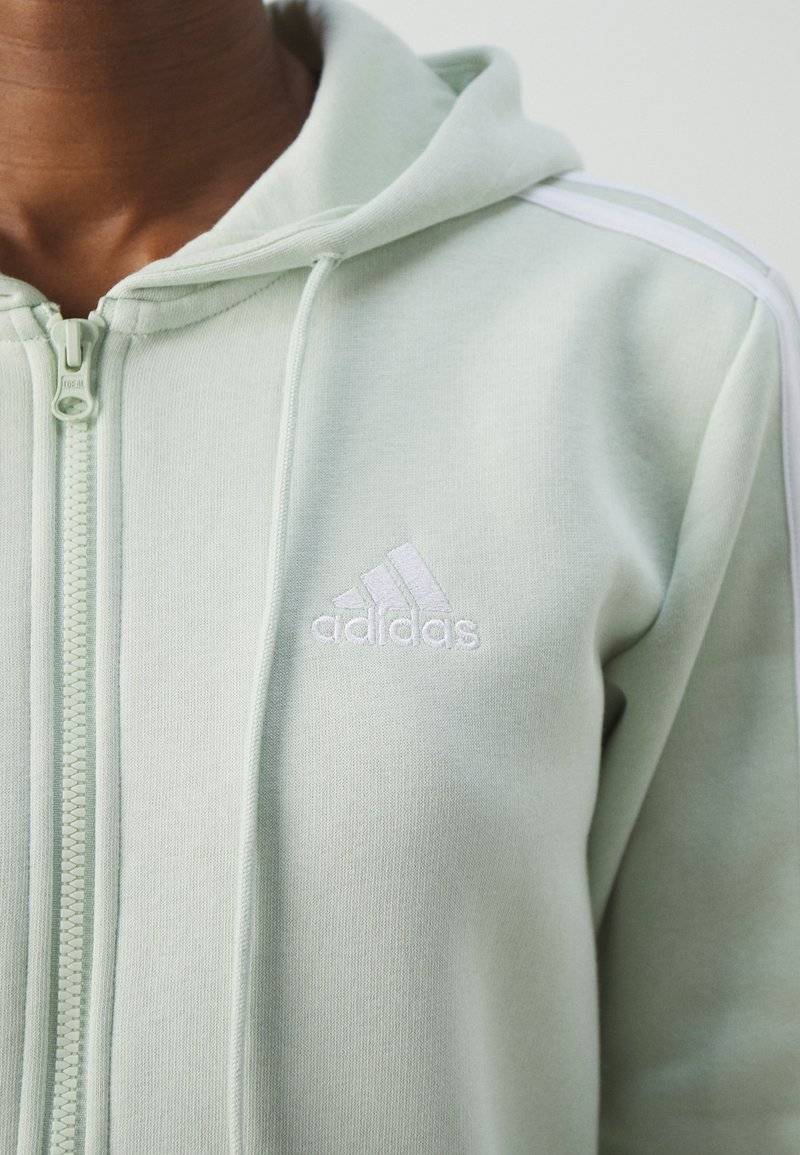 adidas Sportswear adidas Sportswear ESSENTIALS 3 STRIPES FULL ZIP HOODIE - Zip-up sweatshirt - linen green Letzte 2 Tage
