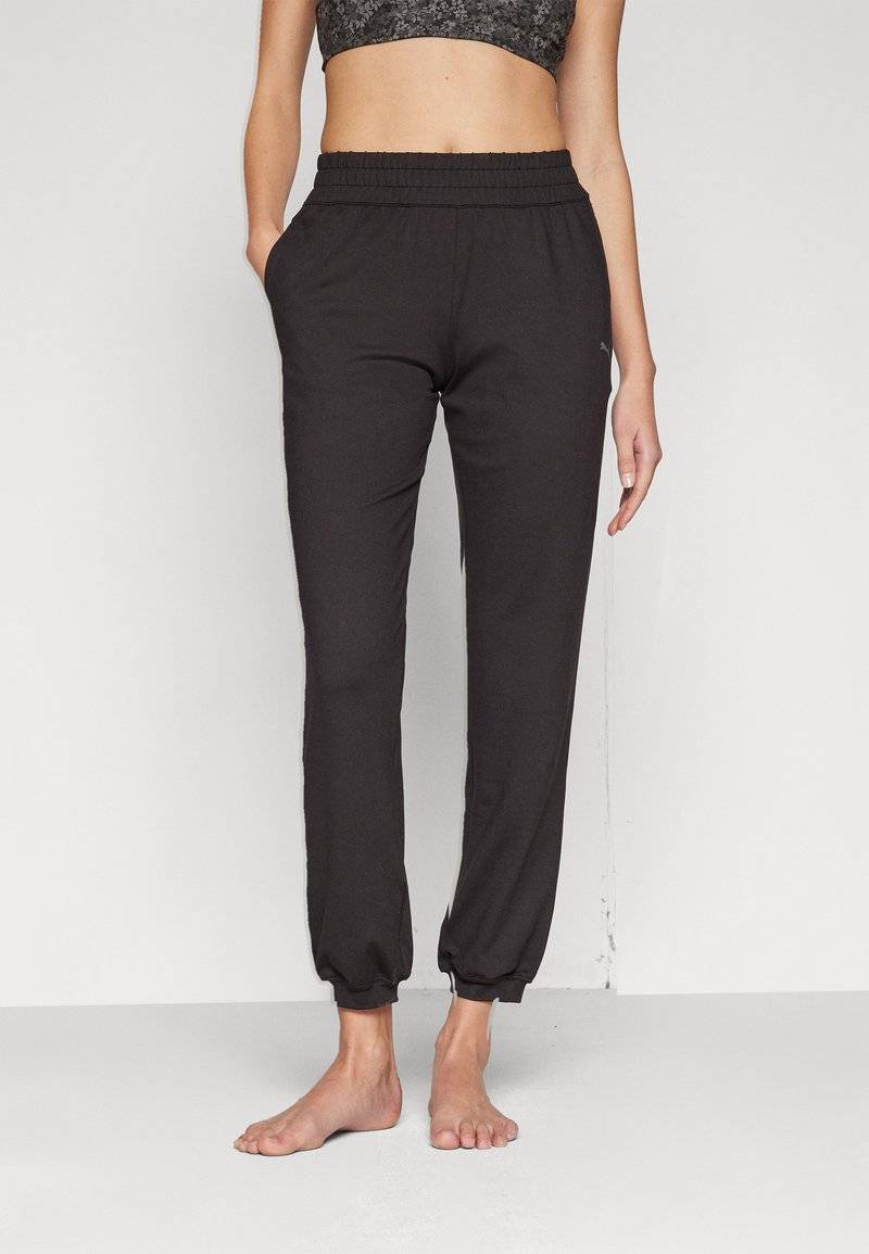 Puma Puma STUDIO FOUNDATIONS - Tracksuit bottoms - black Günstig kaufen