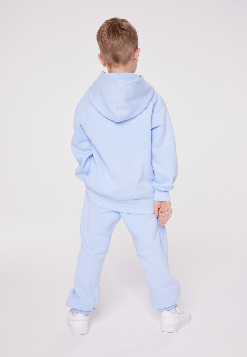 Champion Champion EXCLUSIVE PANT UNISEX - Tracksuit bottoms - light blue VIP-Rabatte