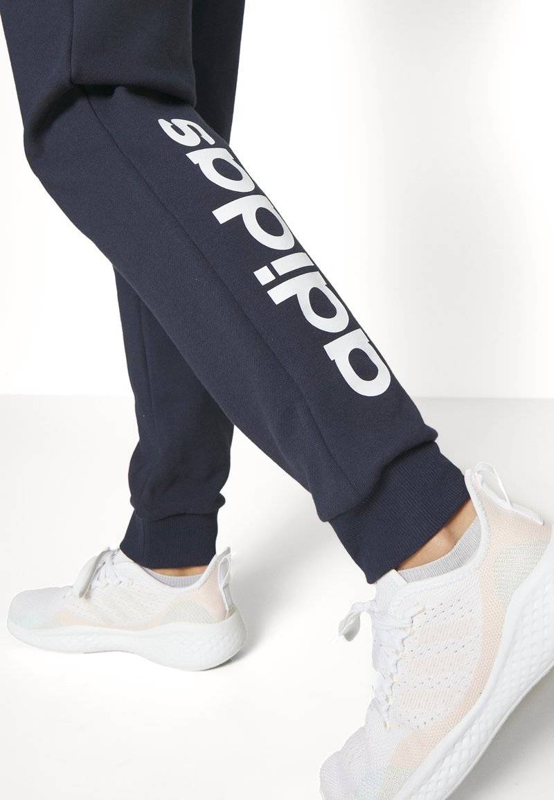 adidas Sportswear adidas Sportswear ESSENTIALS LINEAR CUFFED - Tracksuit bottoms - legend ink Nur noch ein Tag übrig