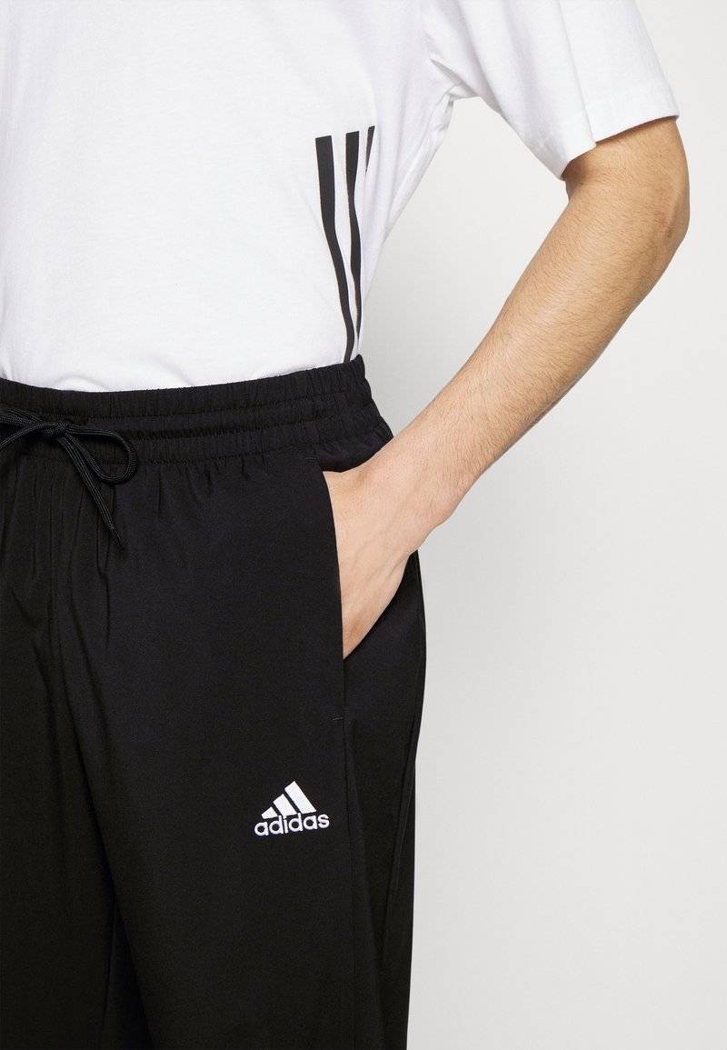 adidas Sportswear adidas Sportswear ESSENTIALS - Tracksuit bottoms - black Online Outlet