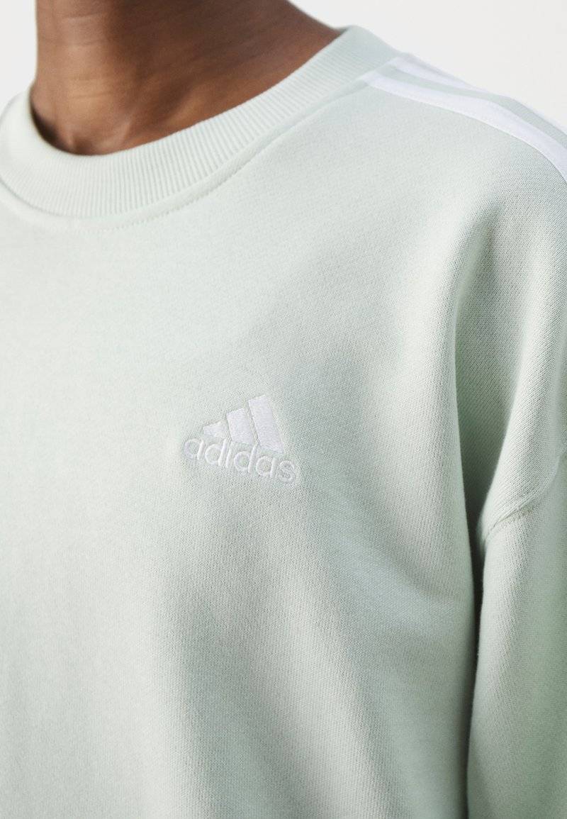 adidas Sportswear adidas Sportswear ESSENTIALS 3 STRIPES - Sweatshirt - linen green zollfrei